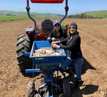 Melissa Williams and Jessica Valentine planting for a trial run of their vodka in 2019