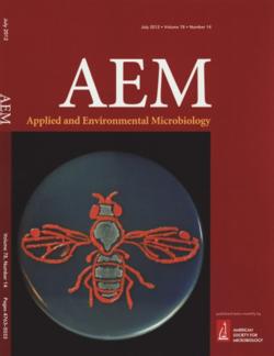 A 2012 cover of Applied Environmental Microbiology featuring Drosophila suzukii research in the Zalom lab.